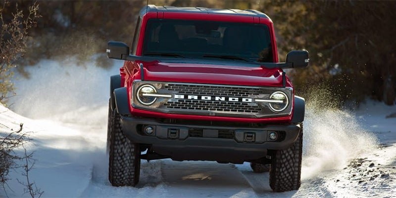 An off-road Ford Bronco standing in snow.